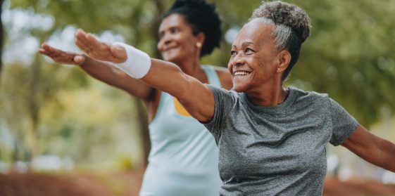 Two mature women enjoying outdoor exercise together